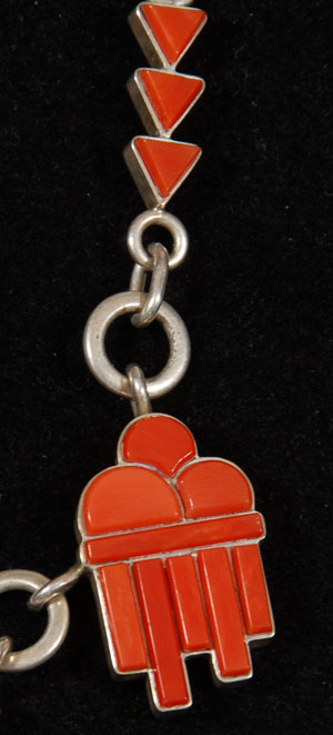 This absolutely exquisite necklace and earring set features flawless coral set in three pendants representing clouds and rain and groupings of triangles representing lightning. The coral is set in sterling silver backing.  The chain is handmade, also of sterling silver.  The clasp is highlighted with a joining bar of a pair of coral triangles.  The earrings repeat the coral cloud and rain theme and feature a secure locking pierced ear clasp.  Each piece of the set is stamped with the artist initials CAE and Sterling.  Christina Eustace is the daughter of Cochiti potter Felicita Eustace and Zuni artist Ben Eustace.  She is a respected jeweler and has been awarded numerous awards at Santa Fe Indian Market, Eight Northern Indian Pueblos Arts and Crafts Show, the Denver Art Museum, and the Museum of Indian Arts and Culture in Santa Fe.  She has been collected throughout the United States and by the British Museum in London, England.  Condition:  the jewelry set is in original excellent condition.  Provenance: from a Santa Fe resident 
