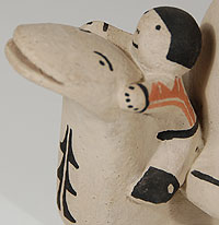 This charming turtle figurine was created by Cochiti potter Buffy Cordero, granddaughter of the famed Helen Cordero.  Helen Cordero was the creator of the "mother turtle" figurine which this represents.  She said that there was a legend at Cochiti that refers to a turtle rescuing the children in time of peril and taking them to safety.  This turtle figurine with five children astride its back is an engaging figure that brings a smile to one’s face.  It is signed Buffy Cordero Suina. To the best of my knowledge, Buffy is no longer actively making pottery.  I believe she stopped potting before Helen passed away in 1994.    Condition: very good condition after a small repair to the turtle’s tail  Provenance: from a gentleman in Missouri  Recommended Reading: The Pueblo Storyteller: Development of a Figurative Ceramic Tradition by Barbara Babcock, et al. 