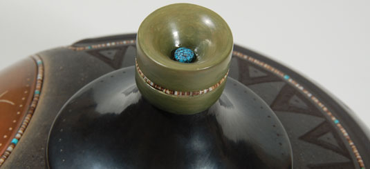 Top View- The lid is polished black with polished green slip at the tip.  A string of hieshe is imbedded into the green slip and a Kingman turquoise cab rests on the top.  Russell suggests that the jar is equally attractive with or without the lid—a decision left to the collector.