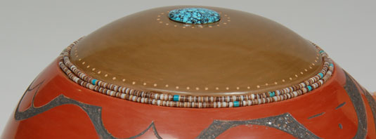 Two rows of high quality shell and turquoise hieshe are imbedded into the clay between the green and red colors.  A single beautiful Black-web Kingman turquoise stone is in place on the top of the turtle’s back.  