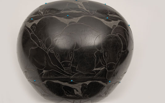 This large black jar is inscribed throughout with beautiful imagery of American Bison.  