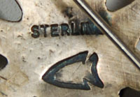  It is stamped sterling on verso and has an arrowhead logo of the maker, however, we have not yet determined the maker to whom that logo belongs.