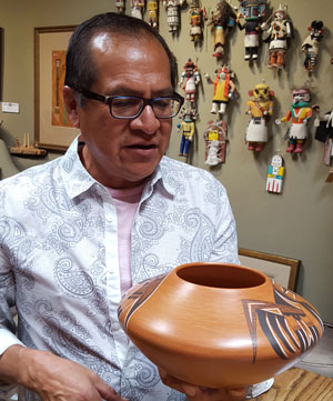 Mark Tahbo of Hopi Pueblo speaks with Alexander E. Anthony, Jr., owner of Adobe Gallery.