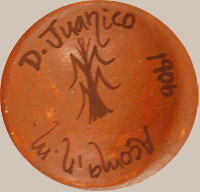 Delores Juanico (1969 - ) signature. Delores creates miniature pottery and applies designs from published historic pottery.  This jar has a design she chose from a published Acoma jar from circa 1906.  She acknowledges this by putting the date of the original jar on the bottom of her jar.  