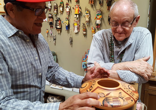 Mark Tahbo discussing his birds on Pueblo pottery.