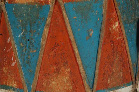 Close up view - This drum is typical of Cochiti Pueblo drums.  The wall is painted with red and blue triangles with their ends painted white.  
