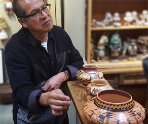 Mark Tahbo with this pot - explanation of design and purpose - including the special clay used.