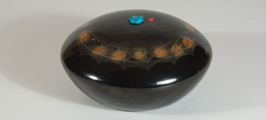 The center of the dome features a large spider with coral for the head and turquoise for the body. 