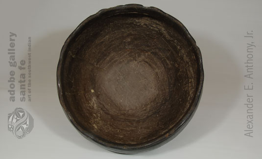 The interior of the vessel was applied with red clay from the pueblo and then stone-polished to a high luster. 
