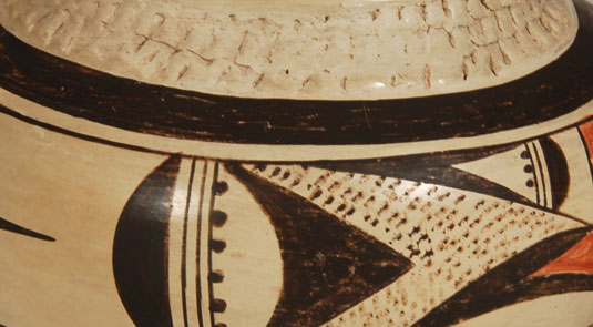 Close up view of the side panel design and the prehistoric style indentation on the neck.