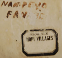 This large seed jar was made by Nampeyo, probably in the 1930s, and painted by Fannie Polacca for her mom.  It bears the dual names Nampeyo Fannie. It also has a paper label attached to the underside that reads From the Hopi Villages, a label applied by Thomas Keam, trader at Keams Canyon.  The jar tilts forward slightly.  There is corrugation around the neck and painted designs on the body.