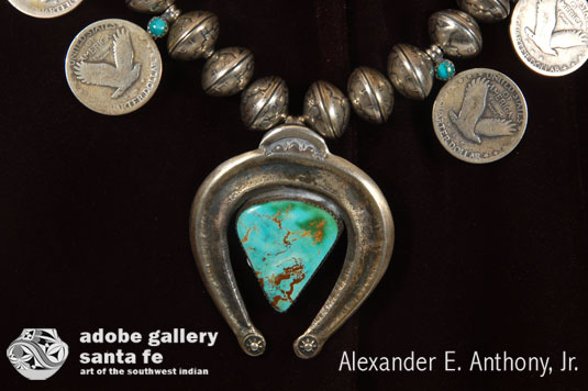 The naja is a horseshoe shape of cast silver with a beautiful blue turquoise stone mounted in its center.