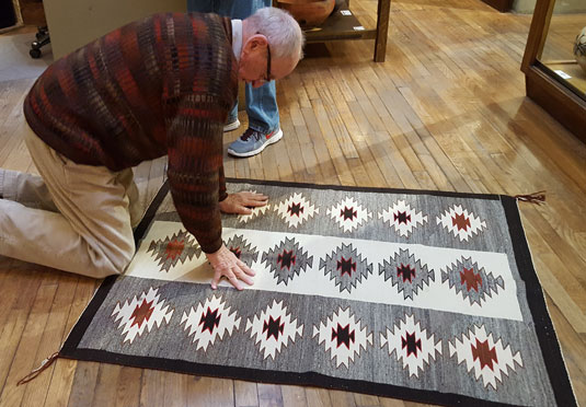 AL is inspecting Rugs coming in for the show