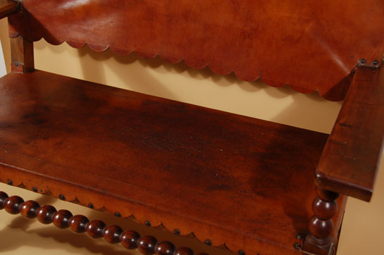 This is the style bench one would find in a Fred Harvey hotel such as The Alvarado in Albuquerque or La Posada in Winslow or any of the other many locations along the rail route from Chicago to California.  It is certainly of the Mission style with the saddle leather back and seat, both of which have curves on the ends of the leather.  There is no manufacturer’s name on the item which leads even more to the likelihood that it was handmade for one of the hotels.  We have no documentation to substantiate this but it could be highly likely.  Condition:  the leather is worn in places and there is a 3-inch slit at the front left seat.  The seat is still useable.  Provenance:  from the Albuquerque residence of Alexander E. Anthony, Jr. where it was used in the front entryway from 1985 until the move to Santa Fe in 2005.  It has been in storage since 2005. 