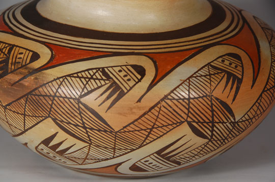 During the late nineteenth century, museums sent expeditions to the Southwest Indian Reservations to make massive collections of pottery and other household items from contemporary homes and archaeological excavations. The result was with mixed blessings. The potters realized that the museums preferred the prehistoric pottery to the contemporary ones, so it did not take them long to realize they could recreate the old styles. Nampeyo was one of the best. There was no intent to deceive the buyers. The potters, including Nampeyo, were making what was in demand and were not concealing that they were new. Nampeyo placed her pottery on a rug out in front of her house and sold it to whoever came by. Her daughter, Annie, was very proficient at pottery making at that time and Nampeyo placed Annie's pottery with her own. Buyers assumed they were buying pottery by Nampeyo and many such pieces made by Annie were placed in museums as being made by Nampeyo. There is no question as to the maker of this polychrome seed jar as it is clearly signed Annie Nampeyo.  It might be assumed that Annie started signing her pottery during the time that her mother was losing her eyesight in the 1930s.  It does not appear that she signed many of her pieces as there are very few that bare her signature. Condition: This jar is in excellent condition.  There is a beautiful orange blush on one side and a fire cloud on the opposite, proof positive of traditional outdoor firing. Provenance:  ex.coll. Phoenix AZ Hopi pottery collector. Recommended Reading: Nampeyo and her Pottery by Barbara Kramer 