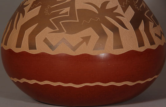 Jody Naranjo is a prize-winning potter from Santa Clara Pueblo who has taken the art form of Pueblo pottery to a brand new level. She has been awarded prizes since she was a teen.  She comes from a family of prize-winning potters and artists.   While continuing the tradition of hand coiling and hand polishing pottery as done by her ancestors she brings a totally contemporary vibrancy to her work.    In this jar a series of spirited riders runs across the shoulder of the vase.  The horses and riders are slipped with micaceous brown clay that rests on an intricate sgraffito background. It is an absolutely wonderful piece that has a sense of freedom and joy about it. The craftsmanship is flawless. The jar is signed and dated 2011.   Condition: This jar is new and in original excellent condition  Recommended Reading:  Pueblo Indian Pottery 750 Artist Biographies by Gregory Schaaf  Provenance: from the artist 