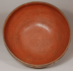 There were probably more bowls made in New Mexico Pueblos than there were jars.  Very large bowls, called dough bowls,  were used for preparing bread dough; medium-sizes ones were used for preparation of tortilla dough, serving food at the table or for storage and even overturned as a lid for covering jars; the smallest bowls were used for daily meals.  This bowl is a medium-size one, and that shows no wear from use.  It was probably purchased when made and was probably made in the 1930s or so.  The rim of the bowl rises up from a slight indention just below.  The design is a sinusoidal wave encircling the vessel.  Condition:  the bowl is sturdy and strong with some minor abrasion of the exterior design  Provenance: from the collection of Katherine H. Rust  Recommended Reading:  The Pottery of Zia Pueblo by Harlow and Lanmon 