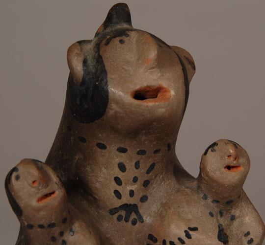 Damacia Cordero was a legend from Cochiti Pueblo. Her storyteller figurines and animal creations were unlike any other potter's work. This storyteller figurine, possibly a male, has the elongated torso, short legs, big ears, protruding nose and flat face of her traditional style.   Touches of red paint were used for the mouths and nostrils of the three and for the belt tying the chonga hairstyle. A Cochiti pottery-type design element decorates the back and the waist of the adult.  Condition:  the figurine is in original condition.  I would estimate it to date to the decade of the 1970s.  Provenance: from the collection of Katherine H. Rust  Recommended Reading: The Pueblo Storyteller by Barbara A. Babcock 