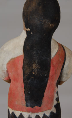 This standing female figurine is not signed with an artist name but we believe it is from Ohkay Owingeh Pueblo, an assumption based on having seen similar figurines in the past.  The brown clay figurine was painted in white paint and her traditional Pueblo dress painted in pink and black, the pink being a shawl draped over the black dress.  Condition:  structurally in original condition.  Minor abrasion of the paint.  Provenance: from the collection of Katherine H. Rust