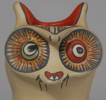 Margaret (b.1936) and Luther (1911-1987) Gutierrez were the children of Lela and Van Gutierrez. Working together, the siblings continued the polychrome style of painting begun by their parents. Sometimes their work is whimsical and other times it is most elegant. This owl effigy figurine is both whimsical and elegant.  The treatment of the eyes expresses the adage of a wise owl through seeing all and missing nothing.  An Avanyu is painted on the front body with a bug peering out from the Avanyu’ s body. Condition:  The owl figurine is in original excellent condition Provenance: from an Albuquerque gentleman Recommended Reading:  Fourteen Families in Pueblo Pottery by Rick Dillingham 