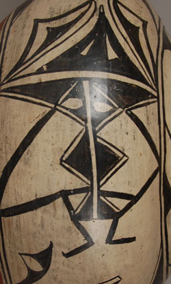 Martina Vigil Montoya (1856-1916) and Florentino Montoya (1858-1918) are considered to be among the best San Ildefonso potters of the late 19th century. This is a beautiful example of what we think is Martina&rsquo;s and Florentino&rsquo;s work, encompassing a great many of the characteristics for which their pottery is so well known and highly regarded.  Attributing work to long-deceased artists is always subject to questions, but sometimes the work just seems to fit the hands of certain artists and it is not wrong to speculate that it was made by them.  That is the case with this San Ildefonso jar.  It has design elements that have been associated with Martina and Florentino.  Jonathan Batkin, in an article in American Indian Art Magazine in 1987 illustrated a number of vessels by this famous couple and there are designs in those that are easily recognizable in this jar.  The kite-like elements suspended from the framing line at the shoulder are illustrated in several of the published pots.   The cresting wave-like elements around the neck that have white centers are easily recognizable as neck decorations in some of the published pots.   This jar has the Cochiti slip that is known to have been used by Marina and Florentino.    Similar pictorial elements like the two birds and the human-like figures do not appear on any of the published pottery by this famous couple but that does not preclude them having made this jar.  We feel that there are sufficient similarities to known examples of their pottery to attribute this jar to their hands.  Condition:  There is a lateral and vertical crack on one side of the jar both of which have been stabilized with glue without any plaster fill or over-paint.  The jar is in stable condition without any restoration, only stabilization.  There is one small pin-head size hole.  Provenance: from an Albuquerque gentleman.  Recommended Reading:  Batkin, Jonathan. &ldquo; Martina Vigil and Florentino Montoya: Master Potters of San Ildefonso and Cochiti Pueblos.&rdquo; American Indian Art Magazine, vol. 12, Number 4, autumn 1987, pp. 28-37. 