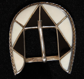 This Zuni ranger set is inlayed in stark black and white using jet and mother of pearl.  The stones are set in silver channels and are precise in size and cut.  The bezels around the stones are surrounded with twisted silver wire as additional decoration.  The set is not signed by an artist.  It appears to be mid-20th century but could be later. Condition:  the set is in excellent condition Provenance: from a gentleman in Illinois Recommended Reading: Zuni Jewelry by Theda and Michael Bassman 