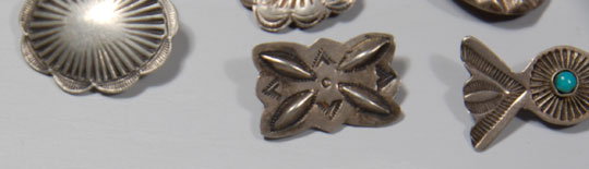 In this group of Navajo-made buttons, there is one set of four that match and all the others are single.  Four have a single turquoise stone and the other buttons are silver only.  Condition:  all are in original condition  Provenance:  from the Balcomb family 