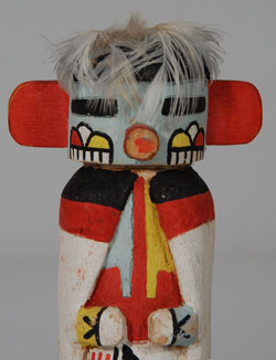 &ldquo;The Talavai Kachina formerly appeared in pairs on the rooftops and sang songs, waking the people in the village. During the day they would dance with the other kachinas that they led and prompted in the singing. This role is no longer used in any of the villages. They still appear with the other Kachinas in the Powamu Ceremony and are most often standing in a set to one side of the main movement of the procession.&rdquo; Wright  Based on the paint used, this doll probably dates to the 1940s decade.  It has been mounted on a black stand which could be removed if one wished to hang the doll.  Condition:  the carving is in excellent condition.  The fan of feathers normally behind the mask has been removed because the feathers were in violation of Federal Regulations regarding feathers of migratory birds.  Provenance: from a California gentleman  Referenced Book: Kachinas: a Hopi Artist&rsquo;s Documentary by Barton Wright 