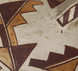 Early in the 20th century, as an inducement to tourists, potters from most of the pueblos adopted vessel forms not traditional to their pueblos.  The depression era was affecting their sales and they were eager to make what they felt would appeal to the few travelers who were venturing to the pueblos.  The early ones were traditional in size and design with only minor vessel shape changes.    This jar, with the restricted neck, fluted rim, and a pair of strap handles is one of the vessel shapes that Acoma potters made in an attempt to appeal to tourists.  The neck is too restrictive to permit use of a gourd ladle and the pair of handles is non-functional for lifting a jar full of water.  These changes to traditional Acoma water jars, although minor, were believed to appeal to buyers who might not like the traditional olla shape used by the pueblo homeowner.    This early period of catering to the desires of travelers was a period where the quality of pottery was still high but it was followed later in the century by a decline in quality when potters started making ashtrays, trinkets and knickknacks.    The quality of this jar is equal to that being made previously.  Only the shape was a compromise and it was not a bad change at all.  It provided variety to the previously-made standardized vessel shape of water jars.  Also, designs on these early 20th century jars continued to be creative and well executed—equal to that being applied to late 19th century vessels.  Condition:  excellent condition for a jar approaching an age of 100 years.  Provenance: from an Albuquerque gentleman  Recommended Reading: Acoma and Laguna Pottery by Rick Dillingham 