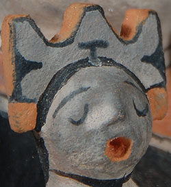 Louis (1932-1997) and Virginia Naranjo (b.1932) were standard bearers for the proud figurative pottery tradition of Cochiti Pueblo. They crafted their figurines at the kitchen table in their comfortable adobe home at the pueblo. They worked almost every day crafting their art with great care, joking and exchanging the gossip of the day as they went along, accompanied by television, children and grandchildren. Their art provided a good life for them and it provided a legacy that will be with us for another century or more.    Louis and Virginia had a wonderful sense of humor. They fashioned figurines in clay of bikini clad men and women with cameras dangling from their necks, mermaids, men with baseball caps, Santa Claus, and many other characters. Also, they crafted angels, storytellers, padres, nacimientos and pueblo dancers.  This figurine features an adult female wearing traditional clothing and a dance tableta.  The two young girls in her lap are dressed similarly.  The figurine is signed Louis Virginia Naranjo Cochiti N.M.    Condition: original condition  Provenance:  from an Albuquerque pottery collector  Recommended Reading:  The Pueblo Storyteller by Barbara Babcock 