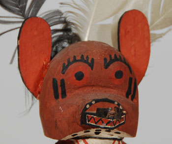 The Wolf Katsina appears with other animal katsinas, serving in the function of a guard. He dances in line with the other katsinas, but then at times will leave the line and move to the fringes of the dance arena insuring that nothing is bothering the other katsinas. All animal dances are prayers for rain and an abundance of game animals.  Whenever Deer and Antelope Katsinas dance, the Wolf is usually there. He is considered a side dancer at those times. In real life, the wolf is prey to the deer and antelope, so the Hopi use him in these dances in the hope that he will use his skill and knowledge to help them capture those game animals.  A gentleman who worked for the Department of the Interior in Denver, Colorado, who passed away in the mid-1940s, collected this Katsina doll; therefore, this carving pre-dates that time period.  Condition:  original condition  Provenance: from a gentleman from California 