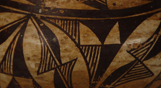 Laguna Pueblo Small Olla Southwest Indian Pottery Historic Laguna Pueblo Refugees from Acoma and other pueblos established Laguna Pueblo a few years after the Pueblo Revolt of 1680. As a result, its pottery is very similar to that of Acoma Pueblo, and, for the most part, is indistinguishable from Acoma ceramics. Sometimes, designs can be a distinguishing factor. The domino-type slanted bars in black with lines in their centers are much more an identifiable design element of Laguna than Acoma. Additionally, the black design elements below the neck are often seen on Laguna pottery. We are using these criteria to attribute this jar to the hands of a potter at Laguna Pueblo. Should someone else disagree with this attribution, and state that the origin is Acoma Pueblo, that would be acceptable as there is much disagreement on distinguishing Laguna from Acoma ceramics. The rim of the jar is black and is without interruption. A wide framing line, also uninterrupted with a ceremonial break, separates the rim and body designs. A thin framing line near the base appears to have a slight ceremonial break. There is an excellent article in American Indian Art Magazine, Vol. 32, #3, Summer 2007, by Dwight Lanmon, entitled "Identifying Laguna Pueblo Pottery, Circa 1900." Although it applies to circa 1900 pottery, and this jar is probably circa 1920s, the information in the article gives a good understanding of how difficult it is to distinguish between Acoma and Laguna pottery. A second article of interest is entitled "On Distinguishing Laguna from Acoma Polychrome" and it was authored by Florence H. Ellis and published in El Palacio, Vol. 73, #3, Autumn 1966. It is worth reading because it makes distinguishing pottery from the two pueblos even more confusing. The surface of this jar exhibits a patina that easily convinces one that it existed as early as the first quarter of the 20th century. Condition: the vessel is in very good structural condition but there is some loss of design due to water exfoliation. Provenance: from a Santa Fe resident Recommended Reading: Acoma and Laguna Pottery by Rick Dillingham