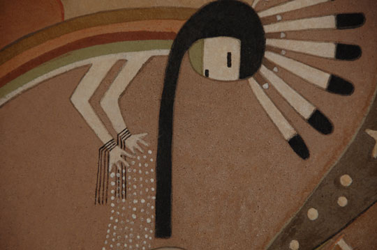 Pablita Velarde enrolled at the Santa Fe Indian School following completion of the 6th grade of elementary school at St Catherine’s Indian School in Santa Fe.  She entered the Santa Fe Indian School as an 8th grader (having skipped 7th grade).  She took an art class under the tutelage of Dorothy Dunn and it became her favorite class.  She said that Dunn had her sit next to her own desk because the boys in the class picked on her since she was the only female in the class.  They did not want a girl in art class.  Velarde said that Dunn taught her to make beautiful earth colors by grinding up different earth minerals with a mano and metate like the ancients had used to grind corn.  Her use of earth minerals for paints continued throughout the rest of her life.  I was not aware that Velarde started with earth mineral paints as early as the 8th grade.  I have always assumed it was something she discovered as an adult.  This is a very early earth mineral painting that was entered into an unidentified art exhibit in 1960.  There is an entry tag affixed to the back of the painting but it does not identify the exhibit by name.  It is identified as “Rainbow God” by Pablita Velarde.  The tag is dated 1960.  The main feature of the painting is the Rainbow God who appears to be dropping seeds.  Above him on the right upper corner are celestial objects, one of which is shaped like a gourd dipper which probably represents the big dipper.  To the left of the painting is a corn plant above which is the sun with a very happy face.  The full moon is shown rising on the kilt of the god.  If Pablita were still with us she could shed more information on the painting but this will have to suffice for now.  Condition:  very good condition for a painting of a half century old.  There is one very small chip in the far left near the frame half way up from the base.  There are a few spots in the mineral paints but nothing of significance.  A simple wood frame blends in with the painting.  Provenance: from the private collection of a couple from Arizona  Recommended Reading:  Southwest Indian Painting: A Changing Art by Clara Lee Tanner 