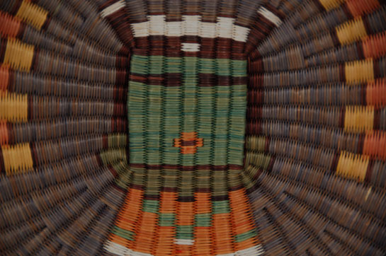 Hopi Third Mesa Wicker Plaque of Kahaila Katsina Southwest Indian Baskets Plaques Hopi Pueblo The earliest collected example of wicker plaques with katsina imagery was by Matilda Coxe Stevenson in 1888; however a photograph identified to 1884 shows a plaque with a katsina image hanging on the wall of trader Thomas Keam's home. It is probably this outside influence by Keam or other non-Hopi that resulted in katsina imagery being placed on wicker basketry. Hopi women were traditionalists and probably would not have taken that step without being requested to do so. Kahaila Katsina is a Hunter Katsina and is believed to have migrated to Hopi from the New Mexico Rio Grande Pueblos. His name is Keresan and he is sometimes referred to as the “eagle feathers erect man,” because of the feathers on his head. We were not able to identify the artist of this basketry plaque. The only indication was a tag with the name Selestewa on it. So, we were not able to determine the full name of the artist. Condition: original condition Provenance: from the collection of an Arizona resident Recommended Reading; Hopi Basket Weaving: Artistry in Natural Fibers by Helga Teiwes