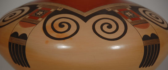 Jacob Myron Koopee passed away in the summer of 2011 at the early age of 41 years. He was the grandson of Marie Koopee, great-grandson of Nellie Nampeyo and great great grandson of Nampeyo of Hano. He was at the height of his career and had received many awards for his pottery. He was accepted as one of the finest of contemporary Hopi potters. His is a great loss to collectors.  This very traditional Sikyatki-inspired seed jar is testament to his talent.  This vessel shape has been acknowledged to be the most difficult to make as the weight of wet clay on the upper shoulder is difficult to keep in place while it dries.  Koopee mastered the technique.  The eagle tail with rectangle and swirls was beautifully and symmetrically applied throughout the upper half of the jar.  Each fine line is straight and parallel to the one next to it.  The spirals or swirls are precise in their application.  The painted design could not have been better executed.  Condition: The jar is in absolute pristine original condition and is spectacularly beautiful.  Recommended Reading: There is a two-page spread of Koopee in Hopi-Tewa Pottery 500 Artist Biographies by Gregory Schaaf.  Provenance:  ex. coll. of a client from Texas 