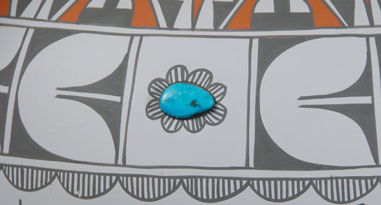 Mary Small is one of the very few potters who today will even attempt to make very large vessels. This large storage jar—almost 17 x 17 inches—is an exceptional piece. It is extremely thin walled and beautifully decorated in orange and gray over a white slip. She inserted 8 turquoise cabochons evenly spaced around the shoulder of the jar.  Mary Small creates traditional and contemporary pottery with unique gray slip and polychrome designs.  This is a technique she created and has been producing for a couple decades and it has been well received by collectors.  Her awards are numerous—1st Place at Santa Fe Indian Market in 1981; 1st Place at Powhatan Renape Nation Indians Arts Festival; Heard Museum; New Mexico State Fair; Inter-tribal Indian Ceremonial; Indian Arts & Crafts Association Show; and Fine Arts Enterprises Show, among others.  Condition:  there are just a couple small areas at the widest dimension where the paint has been rubbed, probably by being pushed against a wall or some similar event. Otherwise, it is in original condition.  Provenance: from the collection of Jeffrey Trent  Recommended Reading:  Southern Pueblo Pottery: 2,000 Artist Biographies c. 1800-Present (American Indian Art Series) by Gregory and Angie Schaaf 