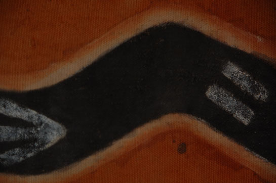 There are a variety of kilts worn by pueblo men during plaza dances.  The most common is a white homespun cotton cloth in a plain basket weave.  It measures approximately 50 inches long by 20 inches wide and is generally folded over at the waist and held in place with a woven belt.  It is the one worn by Hopi Katsina dancers as well as New Mexico animal dancers.  Special kilts are used for special occasions, such as the kilt used for the Hopi Snake Dance.  It is generally of white cotton that has been painted or stained in rust color.  There is a serpentine black band through the center of the kilt, outlined in white, which represents the plumed serpent.  The serpentine band is continuous around the skirt and has neither head nor tail.  White arrow-like marks on the black serpentine band represent the footprints of ducks and the pair of white parallel lines represents the footprints of the frog, both being water creatures.  Similar painted kilts are used by New Mexico pueblos for the Buffalo Dance.  This kilt is a heavy material similar to canvas cloth.  It has been stained rust color and painted with the serpentine band referred to above.  Alternating black and yellow narrow bands are at the waist and the hem areas.  Interestingly, a strip of additional fabric has been stitched onto the bottom of the kilt to make it lengthier.  This kilt appears to be very old in that modern kilts would probably not be patched as this one but would be replaced when necessary.  The kilt has been stitched to a fabric-covered board so that it may be hung on a wall for display.  It could be left in this state or removed from the fabric and displayed in that manner.  Condition: ethnographic wear patterns  Provenance: the current owner is a Santa Fe resident who purchased this item a number of years ago from a Santa Fe dealer, now deceased, at which time it was appraised by another dealer, Ken Canfield, for $3500.  A 2008 appraisal by Santa Fe dealer Ray Dewey was for $4800.  Referenced Publication: Ceremonial Costumes of the Pueblo Indians: Their Evolution, Fabrication, and Significance in the Prayer Drama by Virginia More Roediger 