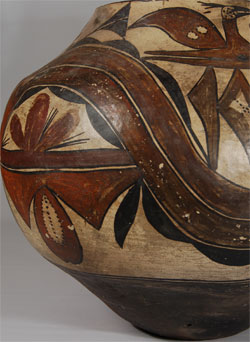 McCarty's Polychrome designation for Acoma Pueblo pottery defines those vessels made after about 1850 and before 1900.  Before then, a designation of Ako Polychrome describes the matte paint pottery produced at Acoma and Laguna Pueblos during the early eighteenth century.  Before 1700, Acoma was known for its magnificent glazed ware.  After 1900, the designation Acoma Polychrome is used. McCarty's Polychrome designation was named for McCarty, an Acoma farming village below the Acoma Mesa.  According to Harlow and Frank (1974), "McCarty's Polychrome vessels have several distinguishing features: 1. The jars are no longer sculptured into a lower and an upper body.  The surface of one part simply curves smoothly to that of the other.  The neck is no longer abruptly differentiated. 2. Once again the walls of the vessels are usually relatively thin, light and strong. 3.  The paste is almost always a clear white color.  The slip, too, is whiter than previously. 4. The decoration begins to incorporate birds and floral motifs.  They are relatively free and informal and more careful in execution." According to Dillingham (1992), pueblo pottery had not shown any strong design influence from non-indigenous sources until around 1850, at which time realistic birds, floral designs, and the rainbow band appeared which were most likely derived from external sources.  Bird designs&mdash;mostly stylized&mdash;had been used since prehistoric times, but the advent of more realistic renditions seems to have occurred around 1850. This McCarty's Polychrome jar is truly magnificent.  It features a double undulating rainbow&mdash;one in deep red, the other in deep orange.  Above the rainbow are three startled-looking birds eagerly eating berries from a plant that they are clutching with their claws.  Below the rainbow, three panels of design, each resembling a combination of a floral element&mdash;perhaps a yucca&mdash;above what may be rain clouds and a cactus leaf, float as if in space.  Condition: This jar is in very good condition with no repairs or restoration. There is a significant amount of fire clouds that attest to a natural outdoor firing.  Provenance: ex. Edwin L. Wade Collection; ex.  Elaine Horwich Collection References:  1.	Historic Pottery of the Pueblo Indians 1600-1880 by Larry Frank and Francis H. Harlow. 1974 2.	Acoma & Laguna Pottery by Rick Dillingham.  1992. 