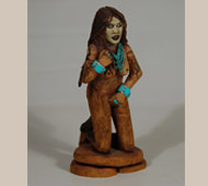 This sculpture is of a Female Skinwalker, which, in Navajo legend, would be much rarer than a male Skinwalker. There are several varieties of Navajo witches, one of which is using his (rarely her) powers to travel in animal form. In some versions, men or women who have attained the highest level of priesthood are called "pure evil."   They are human beings who have gained supernatural power by breaking a cultural taboo. Specifically, a person is said to gain the power to become one upon initiation into the Witchery Way. Both men and women can become skinwalkers, but men are far more numerous. It is generally thought that only childless women can become witches.   Larry Jacquez (pronounced Hackus) is a Navajo folk art carver who specializes in the unusual.  He is known to have carved and painted extraordinary objects, accurately depicting the Yeis, Navajo mythology, and the dances and escapades of skinwalkers.  The Rosenaks stated that they were surprised by the appearance of skinwalkers in his work, and doubtful of their very existence, but Jacquez told them that "evil witches do exist."   Some Navajo also believe that skinwalkers have the ability to steal the "skin" or body of a person. The Navajo believe that if you lock eyes with a skinwalker, they can absorb themselves into your body. It is also said that skinwalkers avoid the light and that their eyes glow like an animal's when in human form, and when in animal form their eyes do not glow as an animal's would. Some Navajos believe that if you make eye contact with a skinwalker, your body will freeze up due to the fear of them and they then use that fear as energy against the person.   A skinwalker is usually described as naked, except for an animal skin. Some Navajos describe them as a mutated version of the animal in question. The skin may just be a mask, like those which are the only garment worn in the witches' song.   This carving of a female skinwalker is naked as skinwalkers are thought to be.  She has the body, from the waist down, of an animal including a tail.  She is elaborately decorated with turquoise jewelry.  Her face is painted a ghostly white.   This carving is signed on the underside "Evil Pleasures" Navajo female skinwalker '01 L. Jacquez.   Condition:  very good condition with only one string on the right bicep partially missing. Provenance: from the collection of Jan and Chuck Rosenak Recommended Reading: Navajo Folk Art by Chuck and Jan Rosenak Referenced Material:  the information on female skinwalkers was excerpted from the online source of Wikipedia.