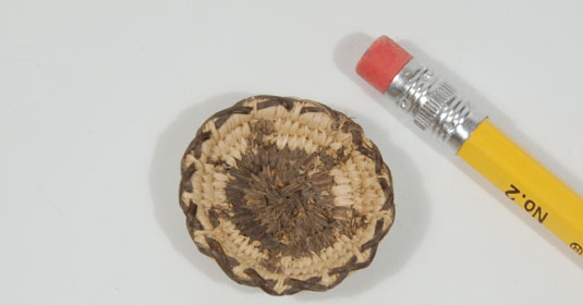 Example of the miniature scale of this Pima Basket with Turtle Design.
