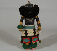 This Salimopia is one of twelve Salimopia. There are two for each of the six directions. Each represents the epitome of youth, vitality, and beauty. They are messengers of the gods, guides for the Katsinas, and warriors. They are young and their actions are quick and darting. Their masks are nearly hidden behind the ruff of crow feathers. In traditional Zuni form, the arms of the doll have been attached with a nail so that they articulate. Also in traditional Zuni style, the skirt has been elaborately decorated. The body is painted. He carries a yucca staff in each hand and, additionally, in his left hand, he carries sheep scapulae. Yarn is used for the ruff, the armband and ankle bands.  Condition:  very good condition Provenance: from the estate of Michael Frost Recommended Reading: Kachinas of the Zuni by Barton Wright 