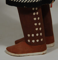 The katsina doll stands erect, with one foot slightly in front of the other, as if in the process of taking a step.