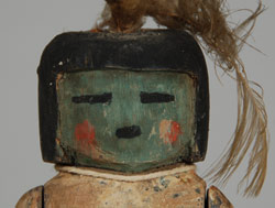When we originally sold this katsina doll to a client in 2003, we were not able to identify it.  Now that we have it back from the estate of that client, we decided to see if we could be more successful in its identification.  As we always do when we are stumped regarding a katsina doll, we consulted Chad Burkhardt, noted Katsina expert.  Our only input was that it was from Zuni, not Hopi, based on the articulating arms and the dense (not cottonwood) wood.  Chad’s comments were that he agreed it was likely from Zuni Pueblo based on style and material but it is not an identifiable katsina representation that he has seen.  He dated it to circa 1940s due to the paint on the legs and feet and the carving of the hands and feet.  When we originally purchased the doll from a client in Kansas City, it was part of a large collection of dolls, approximately 27, all of which were authentic, so we do not doubt the authenticity of this as a Zuni carving, we only do not know what Katsina it represents.  It is an excellent carving that is typical of Zuni workmanship.  Condition:  very good structural condition with a repair to the left hand and missing item in the other hand. Most of the body paint has worn off which is an indication that it was probably natural pigment, not commercial paint. Provenance:  originally from the collection of a Kansas City family 	          most recently from the estate of Michael F. Frost Recommended Reading: Kachinas of the Zuni by Barton Wright 