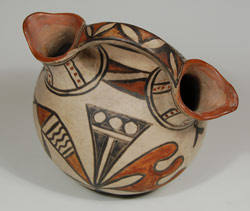 As Jonathan Batkin has well documented, there were several outstanding potters at San Ildefonso during the 1890s whose work can fairly accurately be associated with their names. Following publication of Batkin's studies, it has become easier today to identify late 19th and early 20th century pottery to artists with some degree of accuracy, or so we hope. One husband and wife team, who were extraordinary artisans, was Martina Vigil and Florentino Montoya.   Martina and Florentino have been praised as among the finest artisans at San Ildefonso. Batkin has illustrated a couple of their works in his book Pottery of the Pueblos of New Mexico 1700-1940. It is based on photos in his book that one can identify pottery most likely made by them.  This wedding vase is certainly their creation.  The style and boldness of the design are quite comparable to those pictured in Batkin's book.   This wedding vessel contains rag-wiped Cochiti slip that was introduced to San Ildefonso by Martina and Florentino in the early 1900s, before they moved permanently to Cochiti around 1905. Most potters at San Ildefonso adopted the new slip immediately, but some continued using the old San Ildefonso slip that required stone polishing.  This vessel dates to circa 1910.   Condition:  very good condition Provenance:  the current owner purchased this vessel from Medicine Man Gallery in Santa Fe in 2004 and was provided a certificate attributing it to Martina and Florentino.  The certificate accompanies the purchase. Recommended Reading:  Pottery of the Pueblos of New Mexico 1700-1940 by Jonathan Batkin 