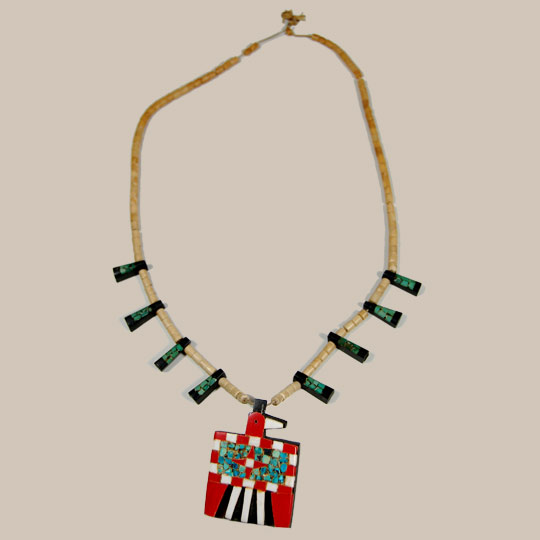 During the 1930s when the Depression-era was in full swing, New Mexico Pueblo Indians were severely affected. At Santo Domingo Pueblo (now Kewa Pueblo), the Indians became very resourceful and began producing jewelry from whatever materials they could find. One particular folk art creation they produced has become a very collectible item: the Depression-era necklace.  Production continued at a lesser rate into the mid-20th century.   This necklace was made from several "found materials." The beads were made from bone, the black backing probably from automotive battery casing, the red from toothbrush handles or something similar, and the turquoise is genuine. These necklaces were usually in the squash blossom style, with pendants protruding from the sides and a bird pendant at the bottom, as is this one.   The dark green turquoise superimposed over the black casing material displays a rich and wonderful patina against the opaque bone beads that also have assumed a warm and old patina.  The Thunderbird pendant is resplendent in all its red and white, particularly the star on the bird's body.  This is a very good example of this style necklace.    Condition:  very good condition. Provenance: from a resident of Colorado Recommended Reading: "Santo Domingo Pueblo Jewelry" by Sally and J. Roderick Moore in The Magazine Antiques, Brant Publications, Inc. July 2009, vol. CLXXVI, no. 1. pp. 56-61.