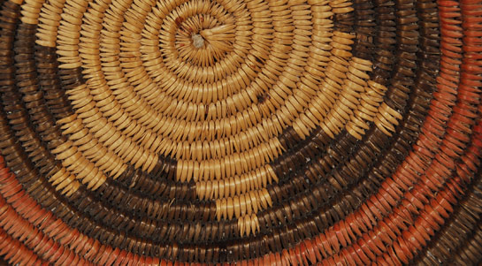 The Navajo ceremonial basket, commonly called the wedding basket, is used by medicine men in all sorts of ceremonies.  The rim of the basket always ends at the same point at the ceremonial line break in the pattern.  This allows the medicine man, in a dark hogan, to find the ceremonial line break by running his fingers around the rim until he finds the end point.  The distinctive feature of older baskets—and this one is older—is the single- or two-rod foundation, resulting in a finer weave and smoother walls than the later three-rod wedding baskets. This appears to be a two-rod foundation.  The rims are always woven in a herringbone pattern. This is a distinctive Diné characteristic that was eventually adopted by the Paiute when they started making wedding baskets for the Diné.  In Navajo baskets, the only colors are black and a deep, russet red. Black is made in several ways, resulting in a range of colors from dark gray to jet. The red results from a mixture of juniper root, mountain mahogany root, alder bark, and burnt juniper needles.  Condition:  The basket is in excellent condition. Provenance: from the collection of a member of the Balcomb family Recommended Reading: Navajo Ceremonial Baskets: Sacred Symbols Sacred Space [SOLD] by Georgiana Simpson 