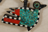 This necklace was made from several "found materials." The beads were made from bone, the black backing probably from automotive battery casing, the red from toothbrush handles or something similar, and the turquoise is genuine. These necklaces were usually in the squash blossom style, with pendants protruding from the sides and a bird pendant at the bottom, as is this one.  Most necklaces of this style have a pendant bird in the shape of the mythical thunderbird, a squared-off bird facing full forward.  This necklace features a more realistic Kewa-style bird as seen on that pueblo’s pottery—a much rarer style of pendant.  During the 1930s when the Depression-era was in full swing, New Mexico Pueblo Indians were severely affected. At Santo Domingo Pueblo (now Kewa Pueblo), the Indians became very resourceful and began producing jewelry from whatever materials they could find. One particular folk art creation they produced has become a very collectible item: the Depression-era necklace.  Production continued at a lesser rate into the mid-20th century.  Condition:  very good condition Provenance: from the personal collection of Margaret Gutierrez of Santa Clara Pueblo Recommended Reading: "Santo Domingo Pueblo Jewelry" by Sally and J. Roderick Moore in The Magazine Antiques, Brant Publications, Inc. July 2009, vol. CLXXVI, no. 1. pp. 56-61 