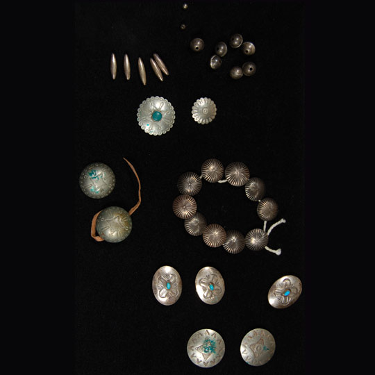 This group is a mixture of shirt buttons, moccasin buttons and silver beads and cones.  They are all sterling silver and, except for the shirt buttons, are handmade Navajo items.  The shirt buttons may be of commercial manufacture.