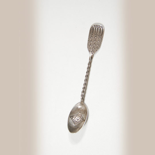 The earliest dated silver spoon known to have been made by a Navajo was in 1885 and that was documented by Charles Lummis in his voluminous notes on file in the Southwest Museum.  Spoons were a favored object of tourists travelling on the AT&SF Railroad that reached Santa Fe (actually, Lamy) New Mexico in 1879.    Potters, at that time, were making large pottery vessels because that was what they were used to making for their own use and expected the train tourists to need the same size for use at home.  It was not readily understood that the tourists were seeking souvenirs, not functional items.  That is where the highly decorated silver spoons developed.  They were perfect items for tourists to drop in a carry-on purse or bag and take back home as a reminder of where they had ventured on vacation.  They were the perfect souvenir.   This spoon features a twisted handle, with a flat section at the end of the handle and a stamped bowl at the other end.  According to Cindra Kline in Navajo Spoons "Twisted handles were so popular in commercial spoon designs of the 1880s and 1890s that they were one of the features of the Robbins Company's 1904 commercial 'Navajo Spoons" [catalog] and were offered in Indian trader catalogs as late as 1906.  Trader J. B. Moore promoted twisted handles as providing 'extra strength.'  In addition, the end result was quite pretty."   Condition: original condition Provenance:  ex Kim Lowndes collection                        Alan Kessler Gallery, Santa Fe                        private collection of a Virginia family Recommended Reading; Navajo Spoons: Indian Artistry and the Souvenir Trade, 1880s - 1940s by Cindra Kline