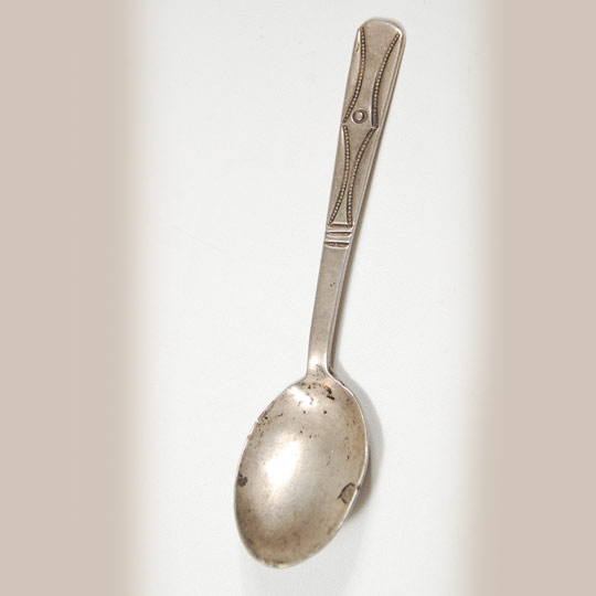 Navajo silver spoons were hand forged from Mexican silver coins or American silver coins. Mexican coins were favored because the silver content was higher than comparable American coins. The coins were hammered into thin sheets and then shaped into the desired form for a spoon.  Once the hammering and forging were complete, the spoon was then stamped with the desired designs.   This spoon appears to be from coin silver as it is heavier and thicker than most.    Condition: it appears that a crack in the bowl was repaired. Provenance:  private collection of a Virginia family Recommended Reading; Navajo Spoons: Indian Artistry and the Souvenir Trade, 1880s - 1940s by Cindra Kline